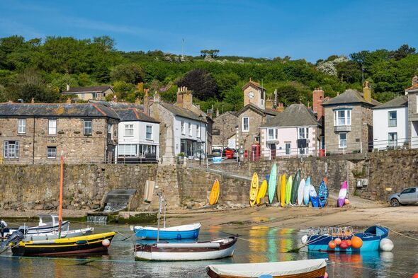 Mousehole Harbour at High Tide with boats in the bay