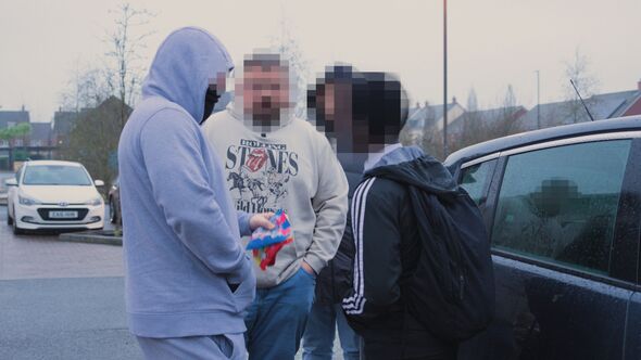 Suspected young shoplifters outside the store