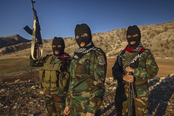 Female Peshmerga soldiers strike a pose.In the turbulent...