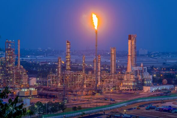 Aerial view oil storage tank with oil refinery background, Oil refinery plant at night.
