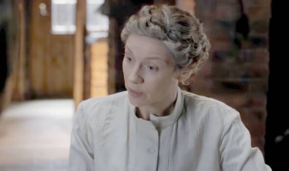 A woman in white speaks