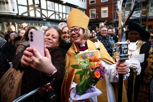 Archbishop of Canterbury Sarah Mullally poses for a picture with a well wisher