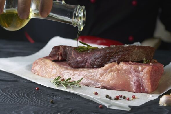 Cooking meat with salt, pepper, spices, herbs and other ingredients. Marinade meat in olive oil with spices and herbs
