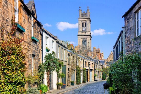 Quaint old residential street with church spire in Edinburgh Scotland during springtime