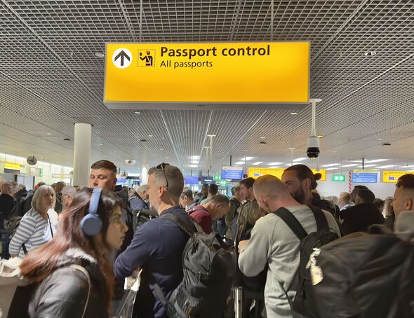 People waiting in line to clear Passport Control at Schiphol Airport, Amsterdam, Netherlands.
