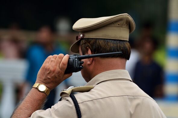 Indian police officer with walkie talkie
