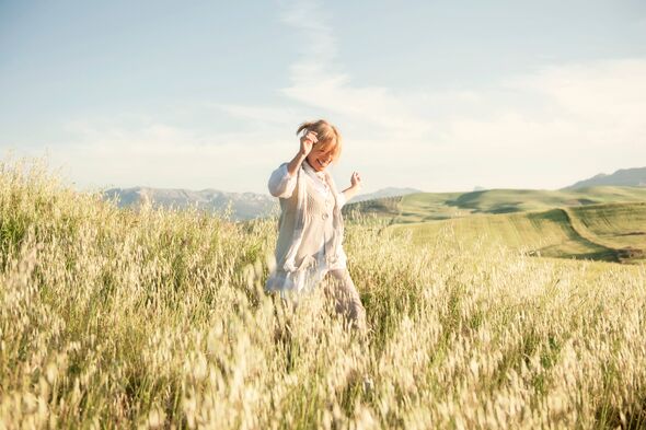 Woman running in the hills enjoying the springtime