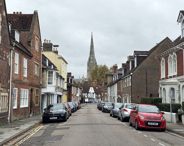 Parked cars and red brick terraced houses
