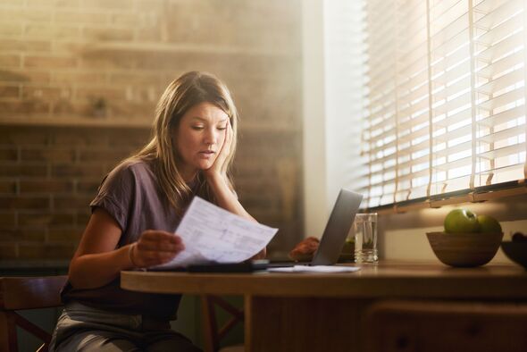 Displeased woman having problems with paying bills online at home.