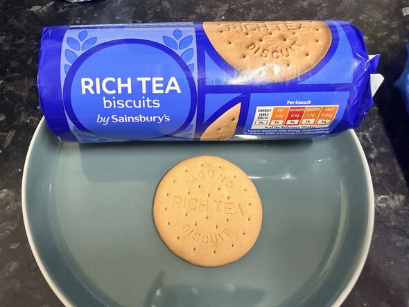 rich tea biscuit on a plate with blue packet behind it