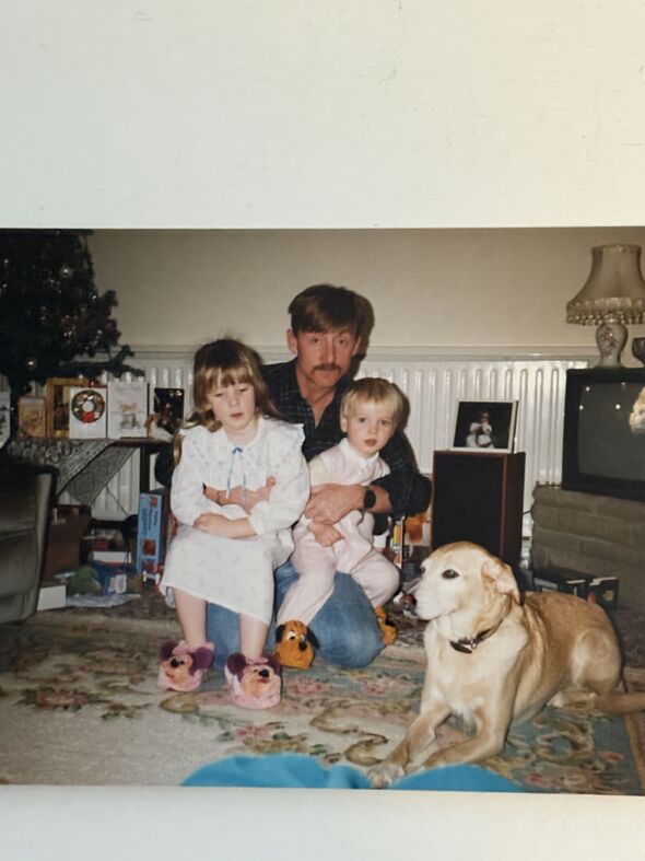 An old picture of a man with his son and daughter