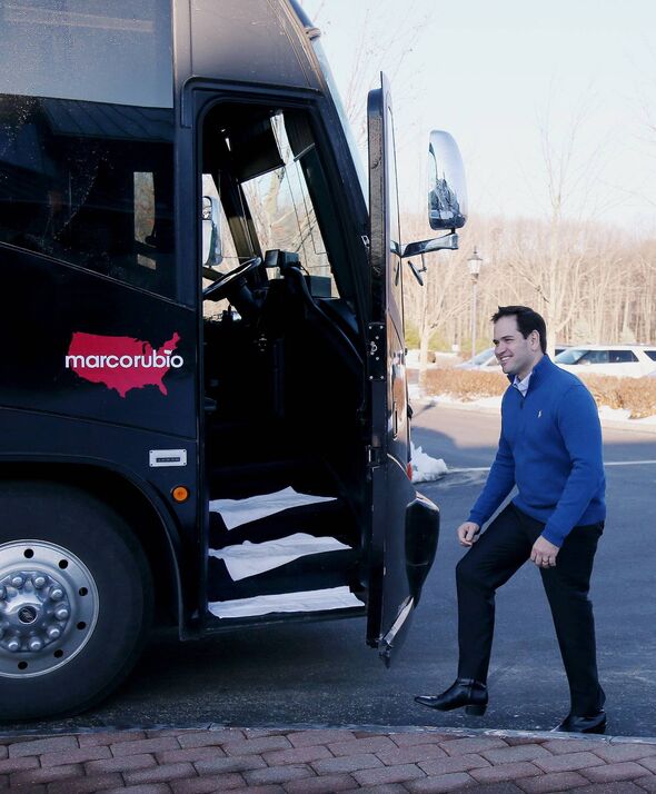 An individual is seen disembarking from a bus featuring a prominent red logo, likely associated with a corporate or organization