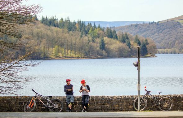 Cyclists enjoy the sunny weather at Ladybower Reservoir