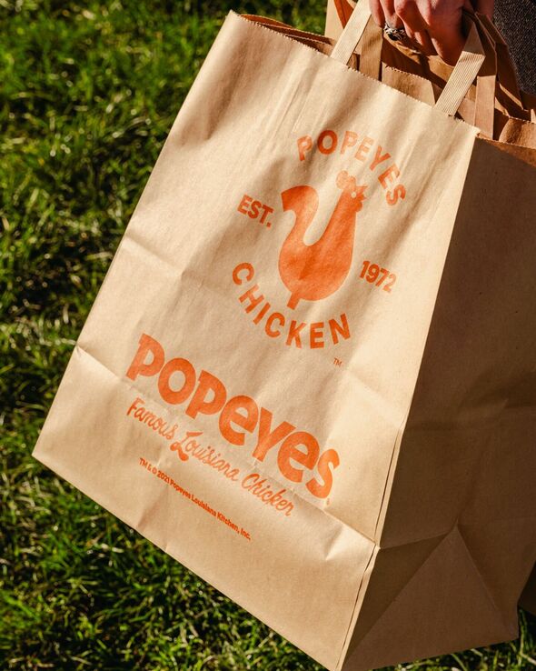 Closeup of a paper bag with Popeyes logo