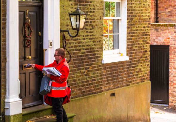 Royal Mail postman delivering mail at house