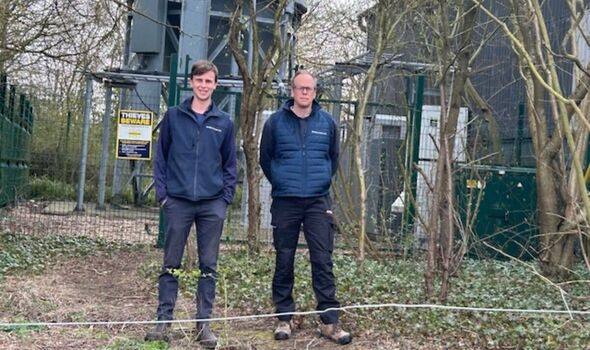 Robert Allison stands with young man on farm
