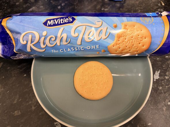 rich tea biscuit on a plate with blue packet behind it