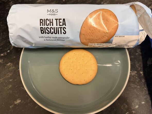 rich tea biscuit on a plate with blue packet behind it