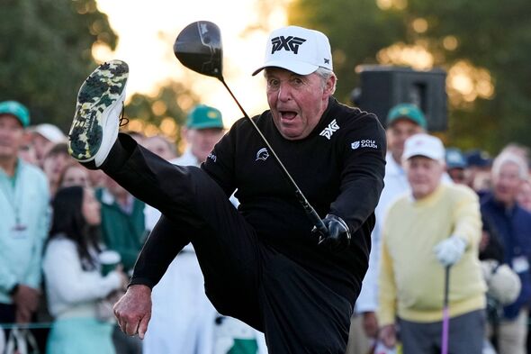 An individual dressed in a black outfit and a white cap, mid-swing with a golf club, appears to be celebrating a successful shot