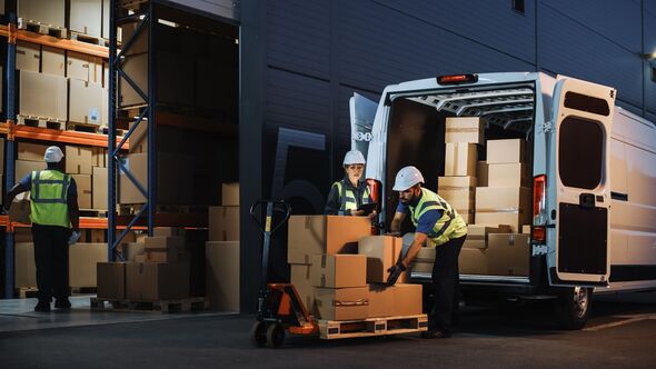 Outside of Logistics Retail Warehouse With Inventory Manager Using Tablet Computer, talking to Worker Loading Delivery Truck with Cardboard Boxes, Onl