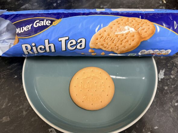 rich tea biscuit on a plate with blue packet behind it