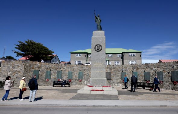 People pictured next to the war memorial, Stanley