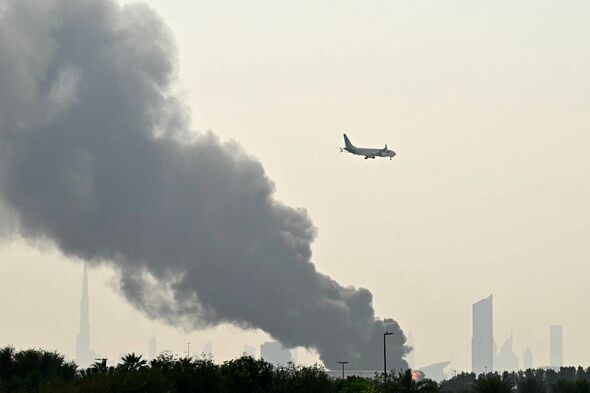 Emirates aircraft flies past fire near Dubai airport as the conflict escalates