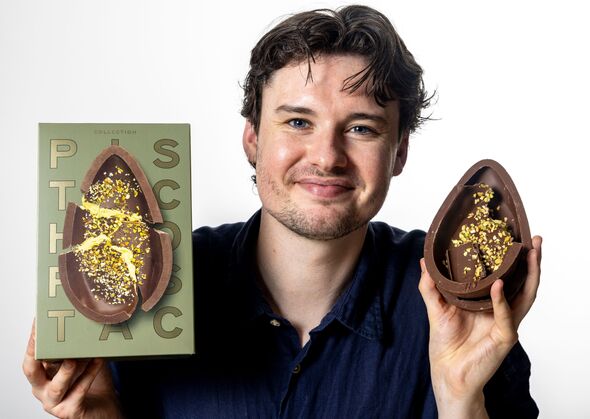 Man holds a chocolate Easter Egg and a green Easter egg box