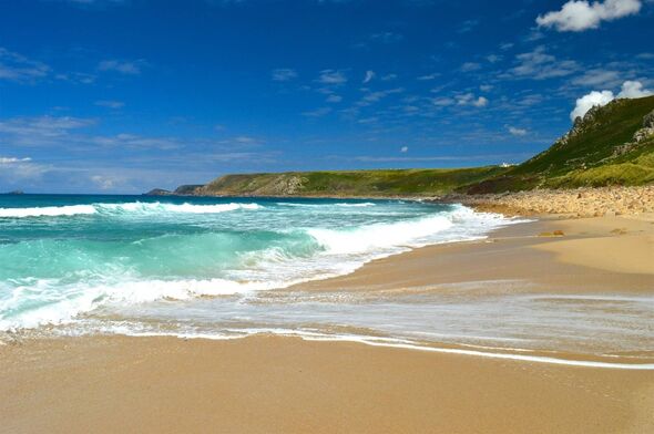 Looking towards the breaking waves on the famous surfing beach at Sennen Cove in Cornwall, taken on sunny summer day in the sout
