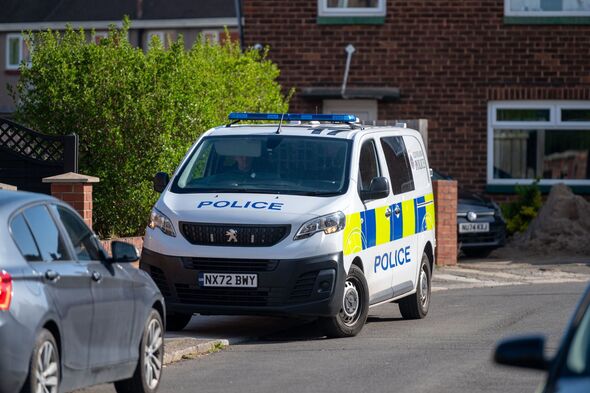 Police vehicle outside the house of the dog attack
