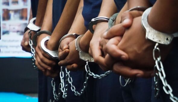 Some of the prisoners' hands were handcuffed with iron handcuffs that were interconnected. criminal concept.