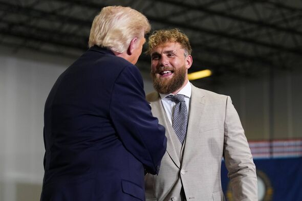 Professional boxer and influencer Jake Paul (R) shakes hands with U.S. President Donald Trump.