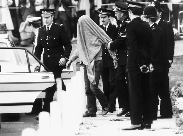 Malcolm Fairley rapist is led away by police September 1984 with his head covered by blanket to waiting police car after a brief