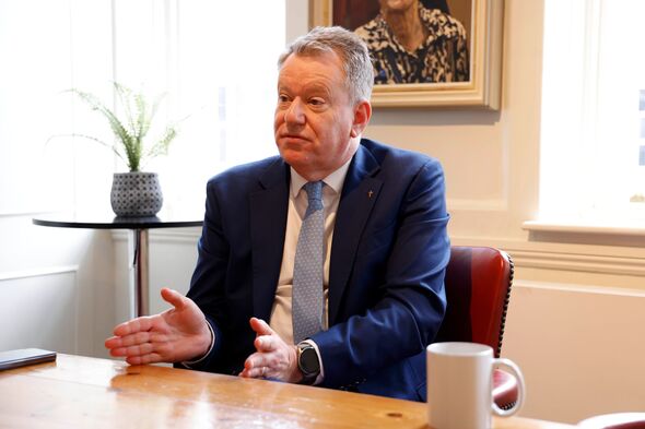Lord Frost at table with mug