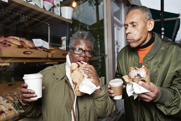 Senior friends eating food in bakery shop
