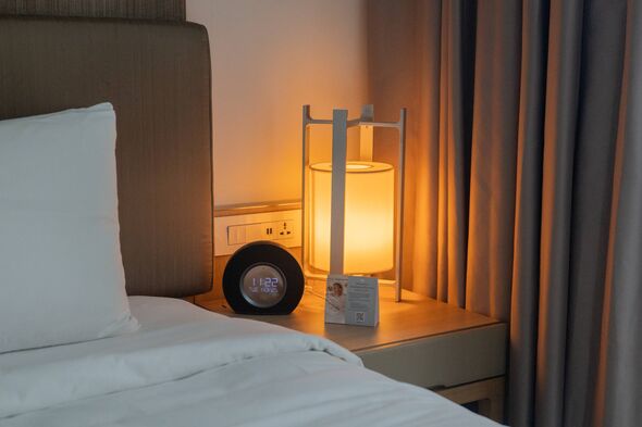 An image of a neatly made bed with white bedding