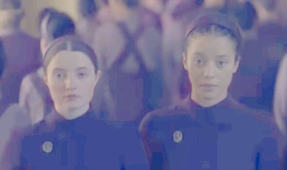 Two girls in purple look serious