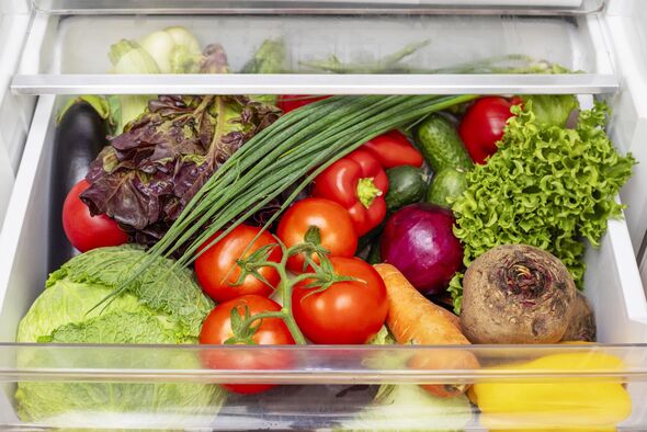 Vegetable compartment of the refrigerator full of fresh vegetables.