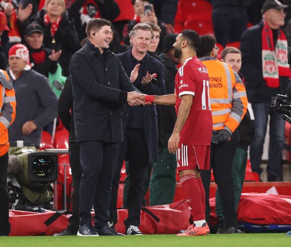 Former Liverpool player, Steven Gerrard shakes hands with Mohamed Salah of Liverpool after the Premier League match between Live