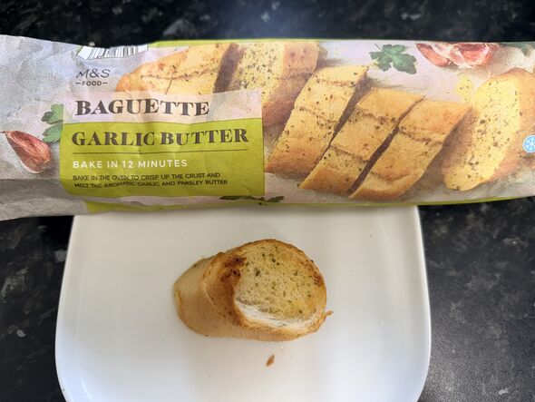 M&S garlic baguette packet and slice on kitchen counter