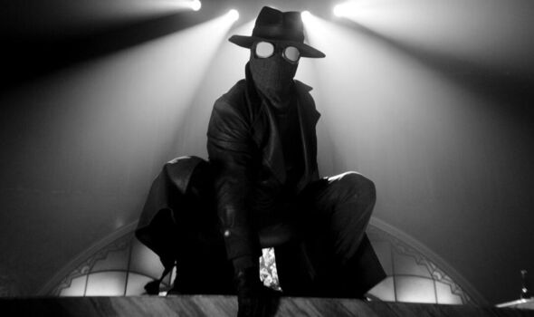 A black and white image of a figure in a mask