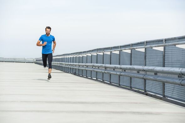 Athletic person running outdoors on an urban road