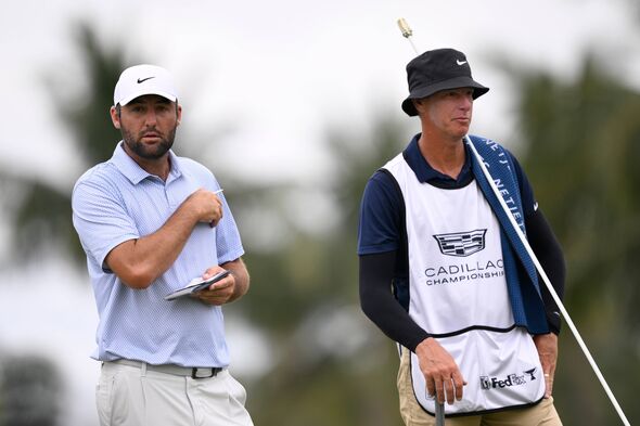 Scottie Scheffler of the United States and caddie Ted Scott look on from the fifth green during the final round of the Cadillac