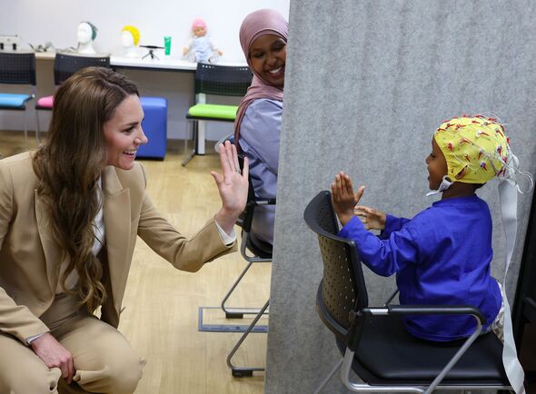 Catherine waves to a child