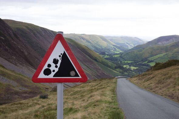 A warning sign showing that there may be falling rocks in the area in a valley in the Cambrian Mountains