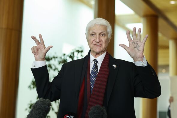 Bob Katter speaks in front of microphones