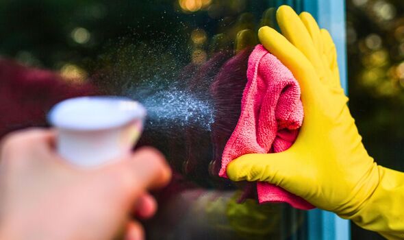 Picture of someone cleaning a window