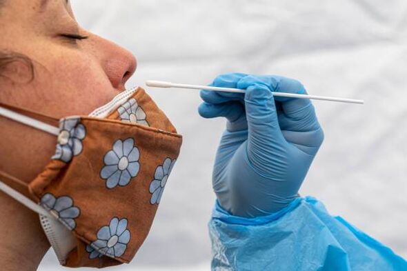 A healthcare worker administers a Covid-19 test at testing site (file image)