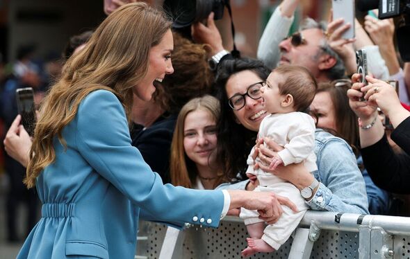 Princess Catherine interacts with a baby