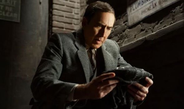 A man looks worried as he stares at an object